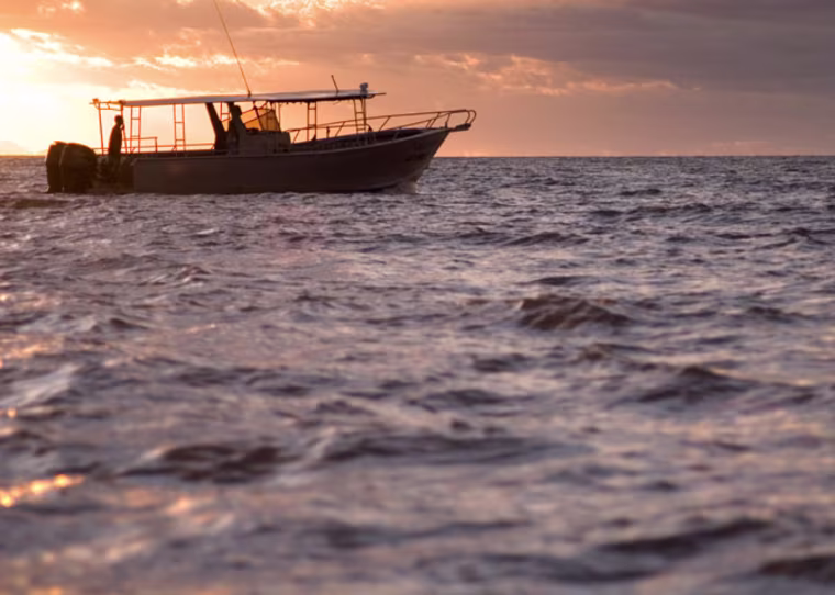 AMH1K7 Fishing boat at sunset, Fiji